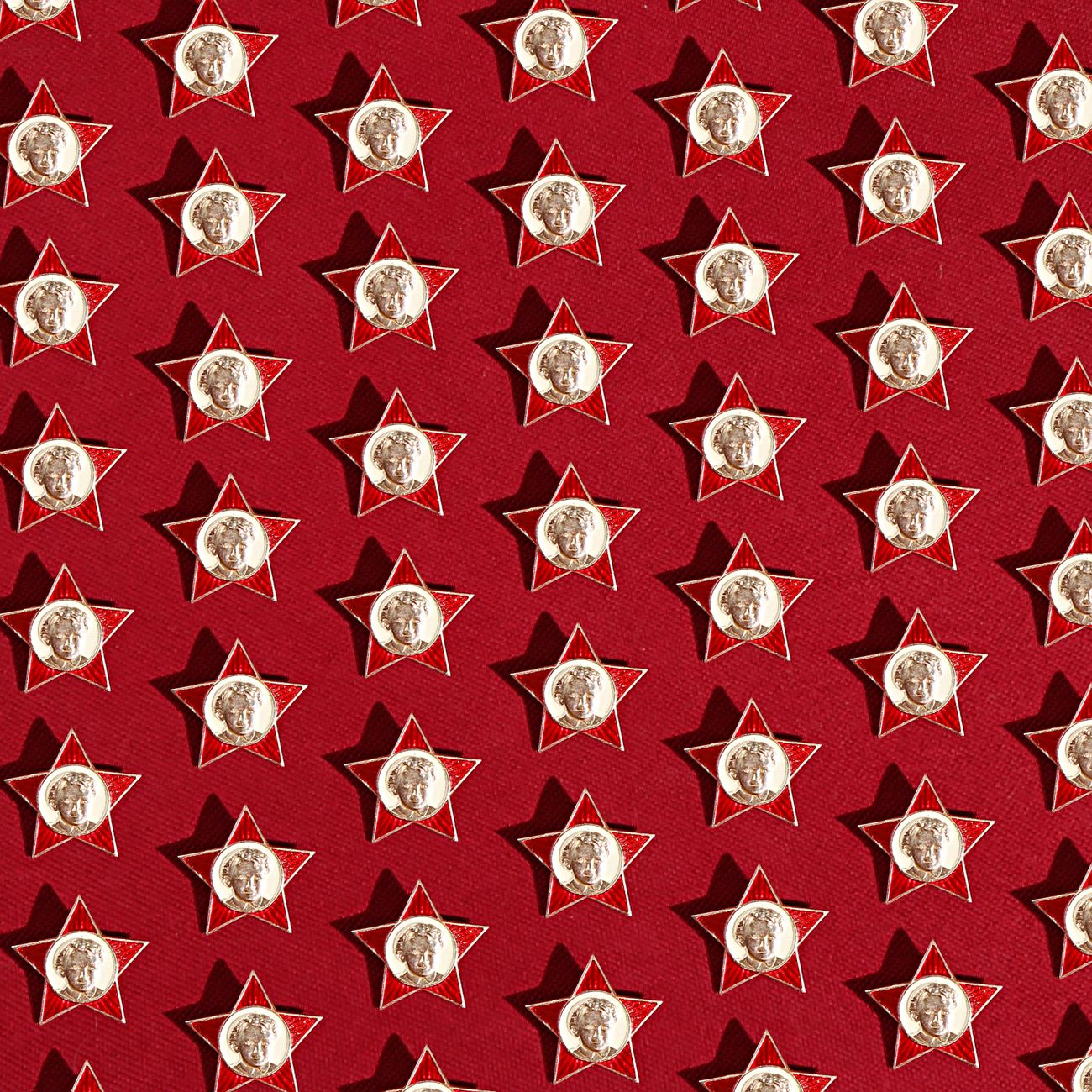 Star-shaped medal pins arranged on a red background